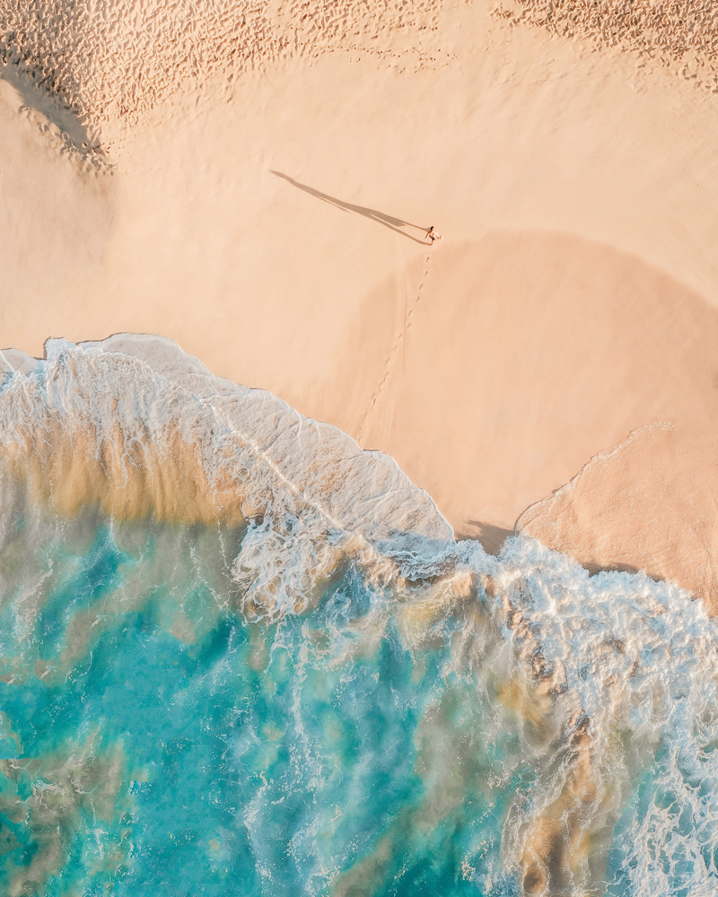 a beach from above with water and sand