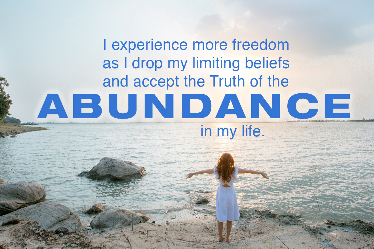 More freedom leads to Abundance - woman standing on a beach
